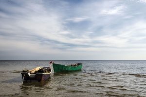 77095441 - lonely boat on the sea at sunset.
